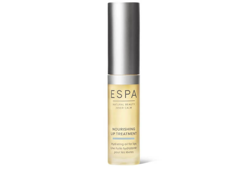 a silver and yellow tube of the ESPA Nourishing Lip Treatment 5ml. On the tube, it says: ESPA, NATURAL BEAUTY, INNER CALM, NOURISHING LIP TREATMENT, Hydrating oil for lips, Une huile hydratante pour les levres