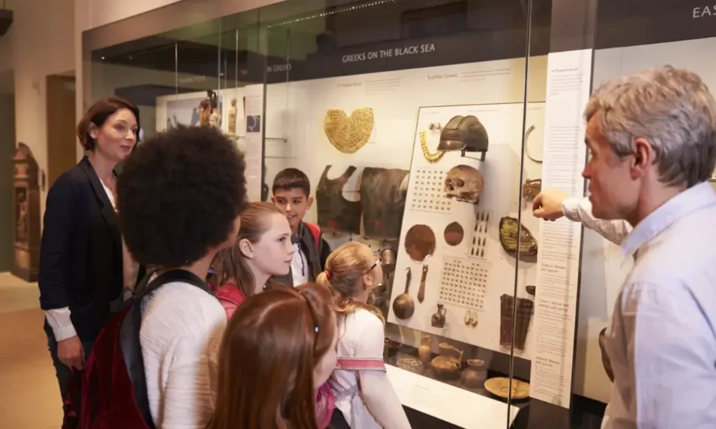 A Man Guiding a Tour About Magical Things of the Museum