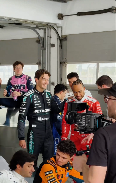 Screenshot of image showing George Russell and Lewis Hamilton in paddock by stuffablog.com