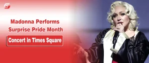 Madonna with platinum blonde hair performing with a microphone on a Pride concert banner for stuffablog.com.